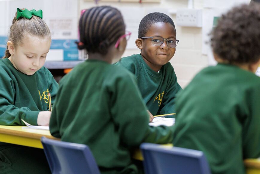 SMSJ Primary Pupils at a Table